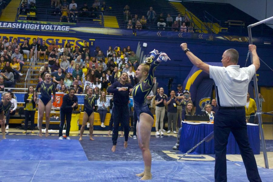 Golden+Flashes+Gymnastics+compete+in+a+Tri-Meet+against+Ohio+State+Buckeyes+and+Eastern+Michigan+Eagles.+A+Golden+Flash+gymnast+sticks+the+landing+in+the+Uneven+Bars+event.