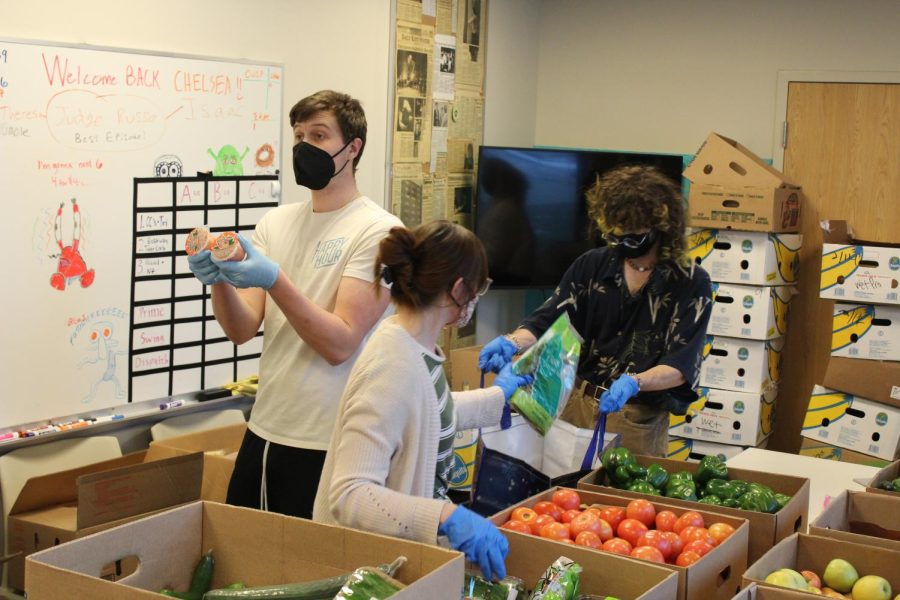 Nathan Ritchey (right) and volunteers packing up a visitors food.