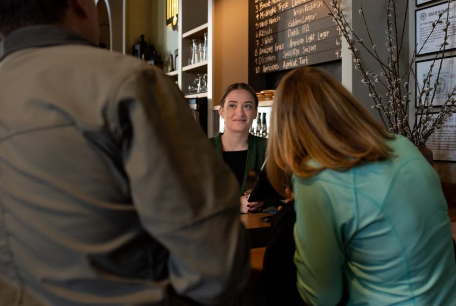 Server Emily Beedlow takes 
a customers order at Bell Tower Brewing Co.