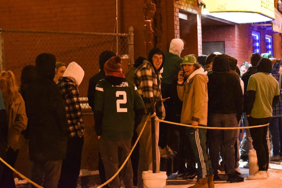 People wait in long lines to get into bars all across downtown Kent despite the cold during Fake Paddy's Day.
