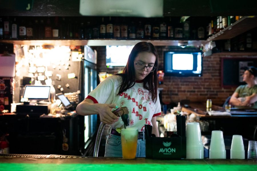 Savannah Ramsey fills the cup with beer at Zephyr Pub on West Main Street in downtown Kent.  