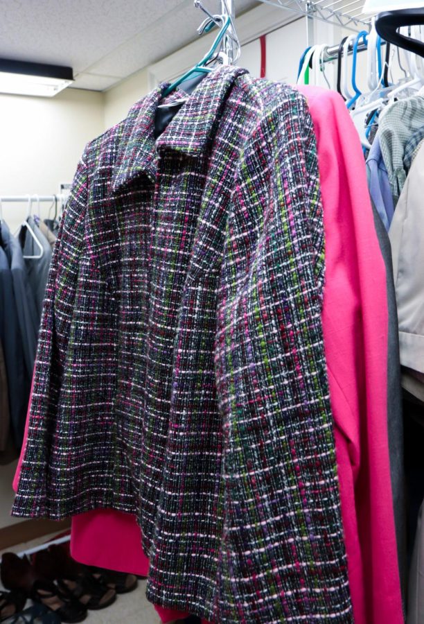 A detailed green and pink jacket in the career closet in the womens center at Kent State University.