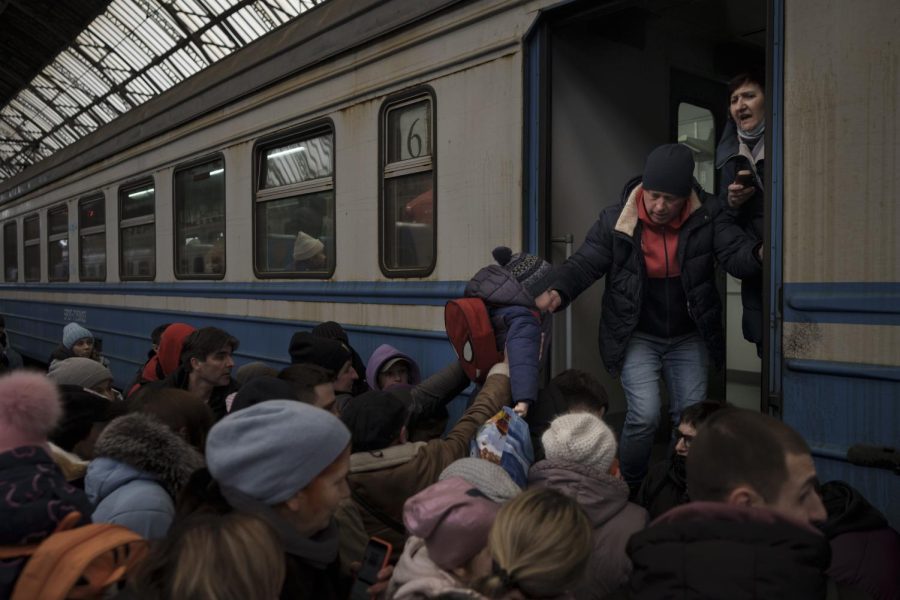 Passengers rush to board a train leaving to Slovakia from the Lviv railway station, in Lviv, west Ukraine, Wednesday, March 2, 2022. Russian forces have escalated their attacks on crowded cities in what Ukraine's leader called a blatant campaign of terror. (AP Photo/Felipe Dana)