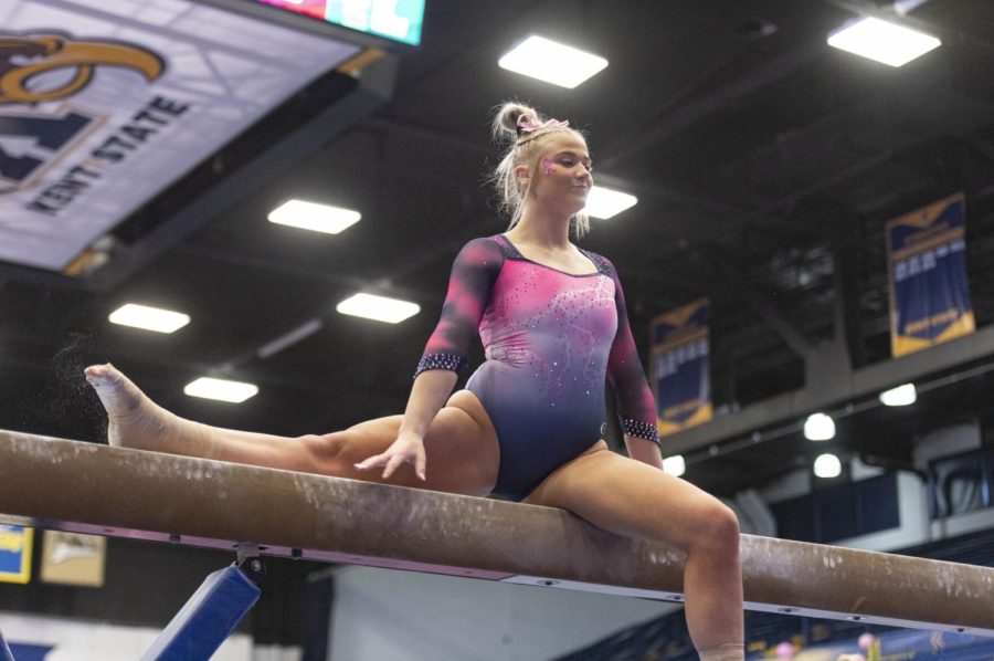 Kent senior Samantha Henry mounts the balance beam during the gymnastics competition against Bowling Green at the M.A.C. Center on Feb. 20, 2022. The judges gave Henry a score of 9.075 for her performace on the balance beam.