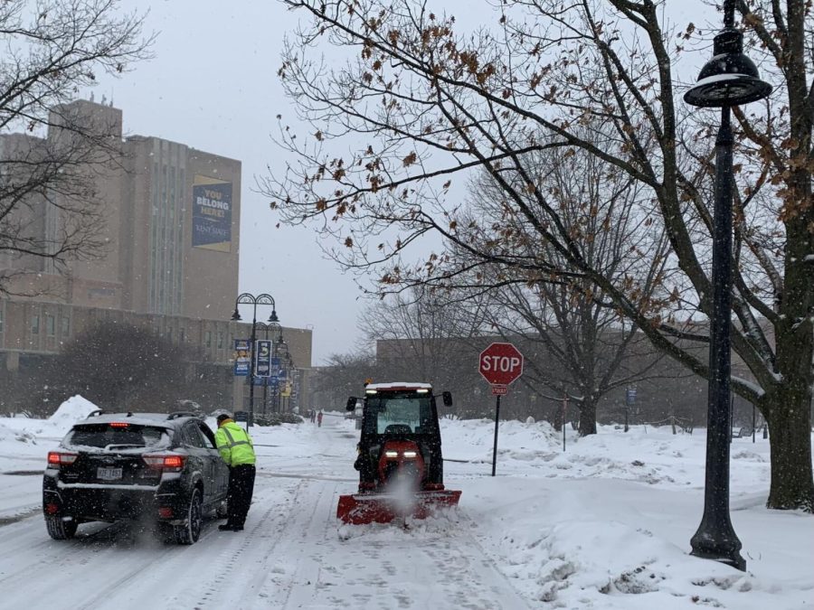 A Kent State operator stops plowing to talk to a driver as snow falls on campus from Winter Storm Landon on Thursday, Feb. 3, 2022. 