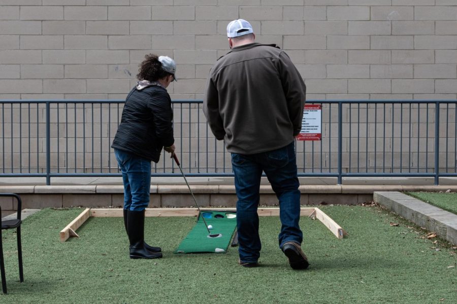A couple putt at the miniature golf course set up in Dan Smith Community Park.