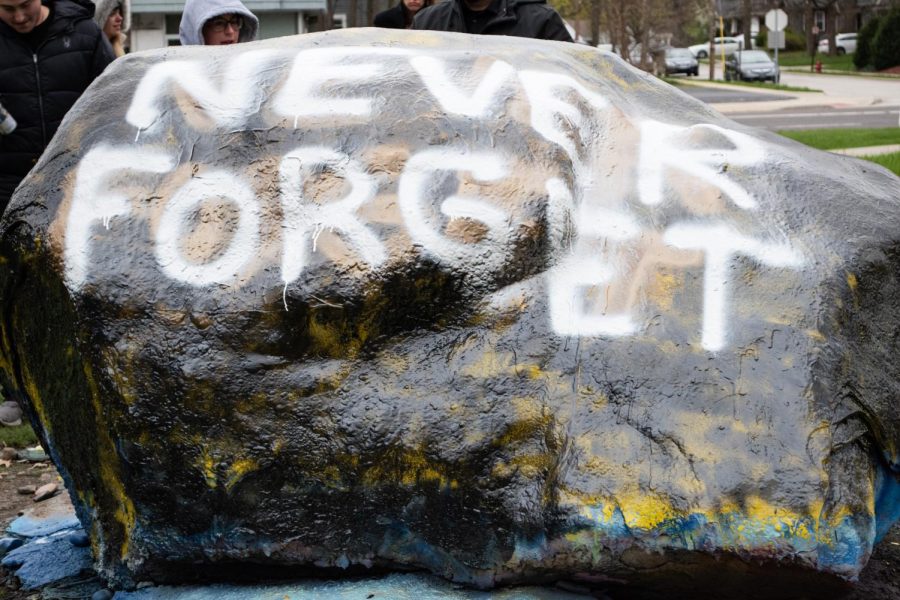The students gathered at the rock to observe Yom HaShoah spray-painted Never Forget on the rock.