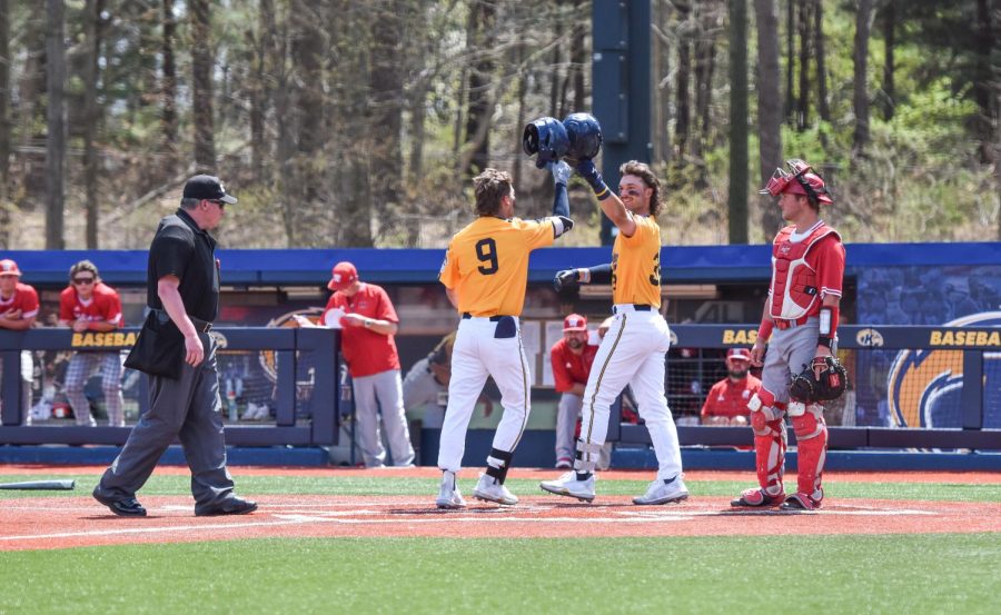 Two Kent State players celebrate after a home run during the game on April 24, 2022.