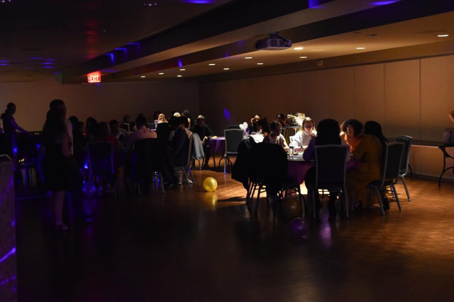 Attendees eat and chat during the Latin Prom on April 22, 2022.