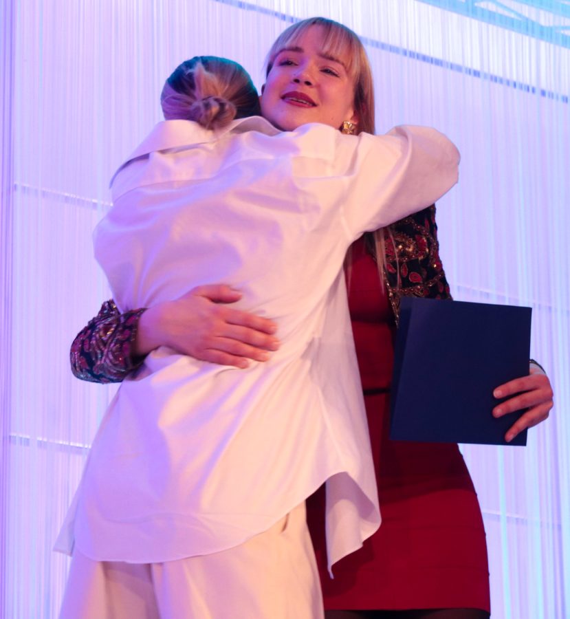 Two award winners embrace after the first in-person fashion show since Covid hit on Friday, April 29.
