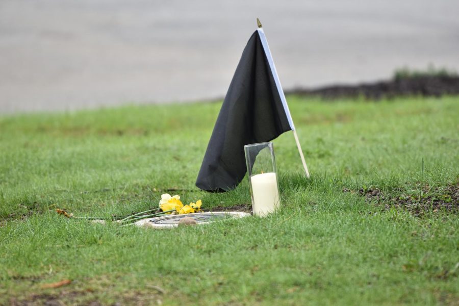A black flag, candle and carefully laid flowers mark the spot where Alan Canfora of May 4 was shot.