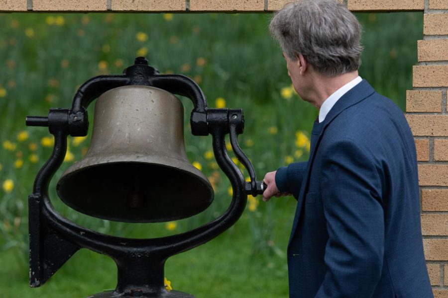 Kent State alumni Tom Grace rings the bell in memory of the victims of May 4.