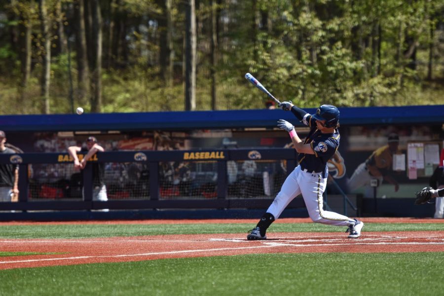 Kent State junior Payton Pennington slams the ball during the first game of the doubleheader on May 8th, 2022.