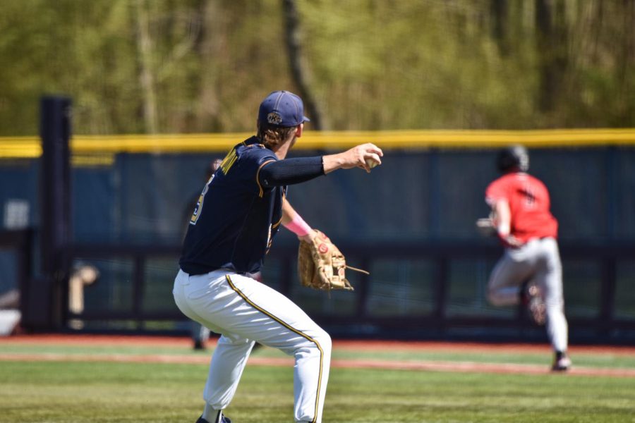 Kent State junior Payton Pennington snags the ball and goes to throw it to 1st base.