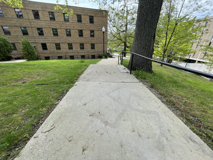The outline of a swastika is visible on a concrete section of a stairway between Engleman Hall, in the background at left, and Verder Hall on the front portion of Kent State’s main campus. 5-19-2022