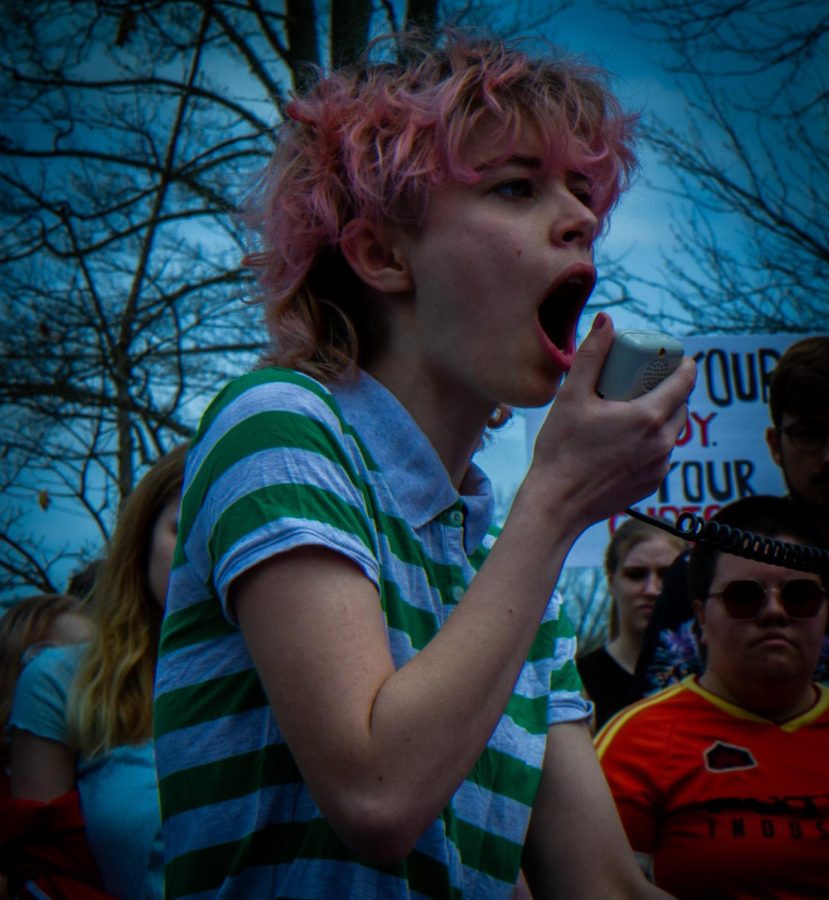 Chloe Proffitt, a Kent State Student, gives the crowd a powerful speech as they stand around her at the rock at the protest for pro-choice rights on Thursday, May 5. She said, they want us to roll over and be quiet and we will not.