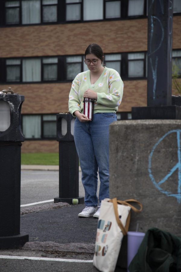 Senior speech pathology and audiology major Meghan Williamson stands vigil in Allison Krauses memorial in the Prentice Hall parking lot on May 4. 