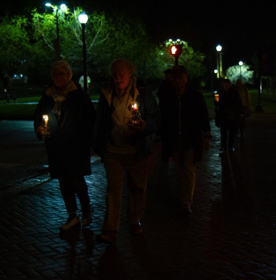 Around 150 people gathered around the bell outside of Taylor Hall to walk downtown in honor of May 4. This couple held their candles in one hand and each others hands in the other throughout the walk.