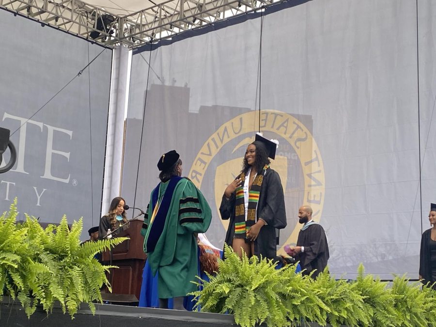 A Kent State student accepts her stole at the Karamu Commencement. She is a nursing major with plans to further her nursing education.