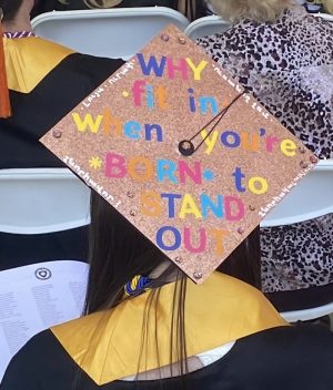 WHY fit in when youre BORN to STAND OUT decorated graduation cap coincides with Diacons speech. 