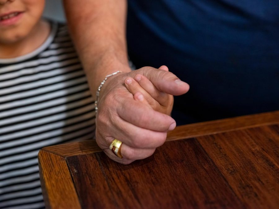 Juan Martínez, co-owner of the restaurant, holds hands with his granddaughter, Jillian Martinez, who is 7 years old.
