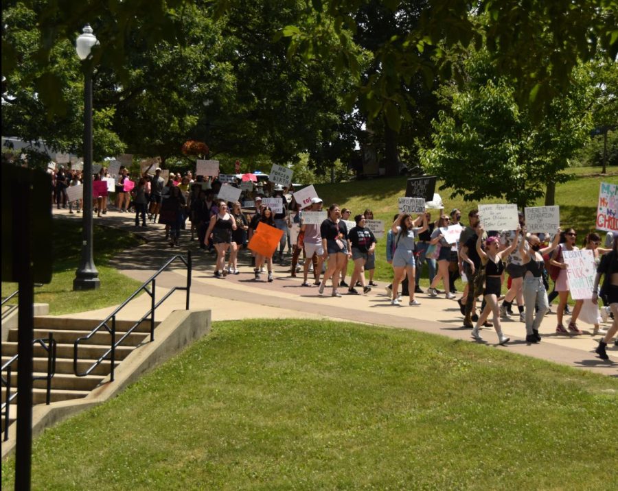 The crowd is led through campus to the Portage County Municipal Courthouse.
