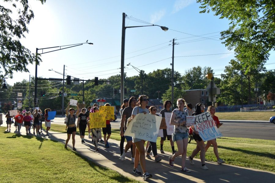 Protesters march to the Kent State Rock to end the event on June 24. 