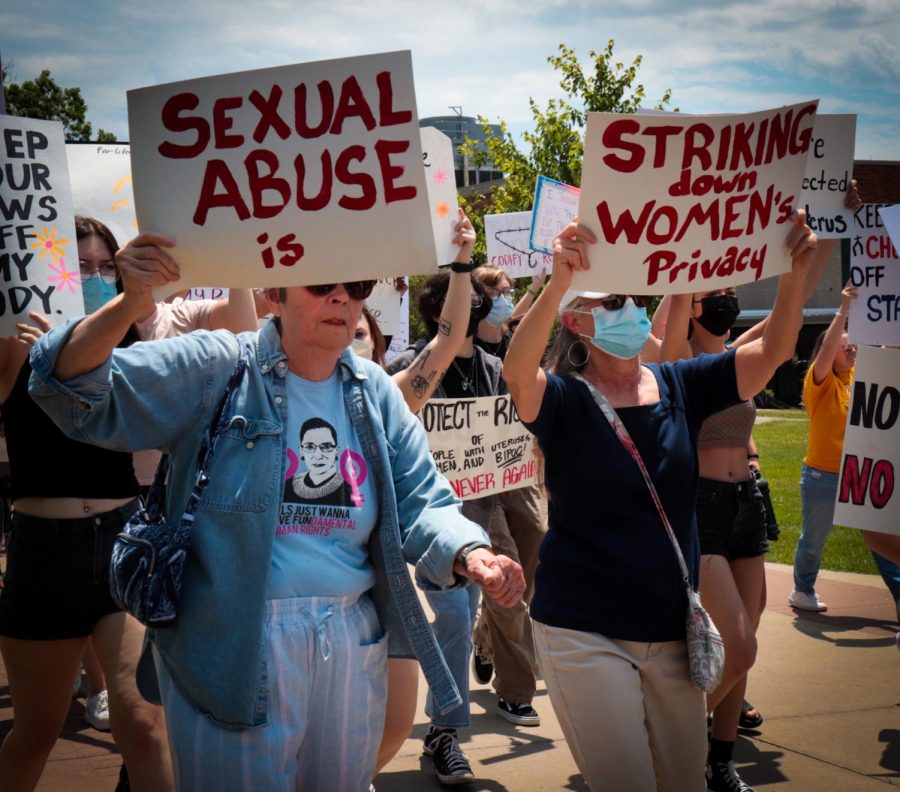 Two women hold signs intended to be read together. The signs stated Sexual abuse is striking down womens privacy. The two were participants at a pro-abortion rights rally at Kent State on Wednesday, June 29.