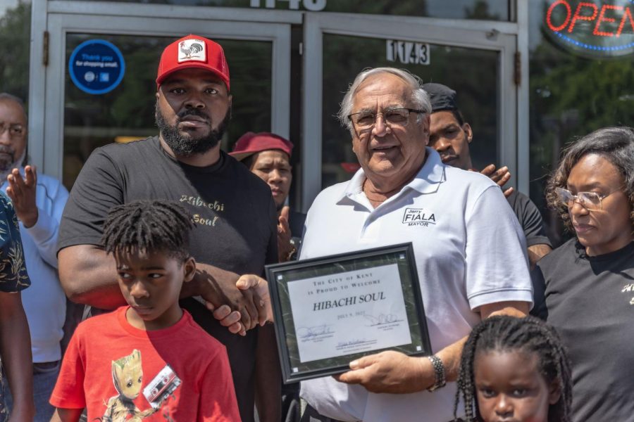 Mayor Fiala (right) presenting a KCC certificate to Donzell Jones (left) for his restaurant, Hibachi Soul, in Kent on July, 10.