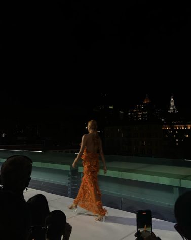A model walks an outdoor runway at New York Fashion Week. Maddie Letourneau attended this show and others like it while attending NYFW this year.