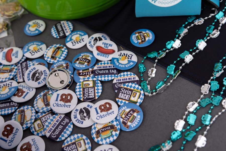 Decorative pins from Oktoberfest are placed on a vendors table. Each person who approached the table was able to spin a wheel for a chance to win one.