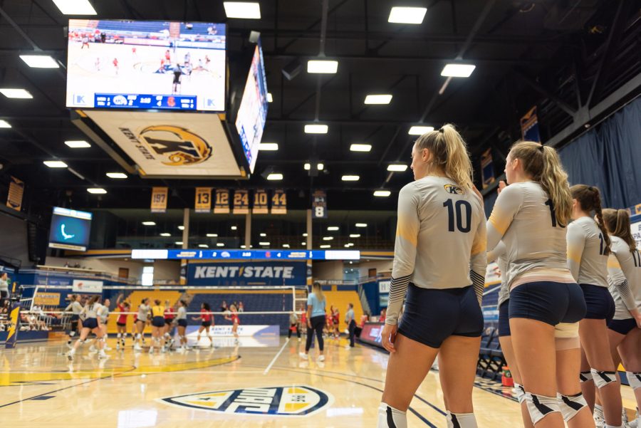 Players Morgan Copley (left) and Lana Strejcek watch as their teammates play on the court. The Golden Flashes continued to cheer on their team against Cornell University.