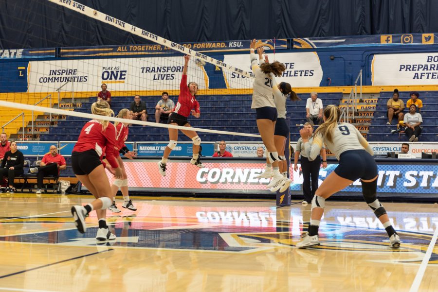 Players Danie Tyson (left) and Alex Haffner get ready to block a hit from the opposing team. The other Golden Flashes on the court prepared for the ball to go over and positioned themselves to bump the volleyball.