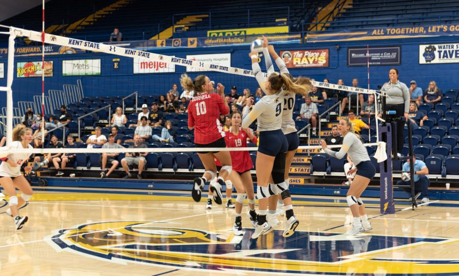 Kent State Womens Volleyball players Taylor Heberle (left) and Danie Tyson jump in the air to block a hit from the Cornell University team. The Kent women played an intense game but were beaten 3-1.