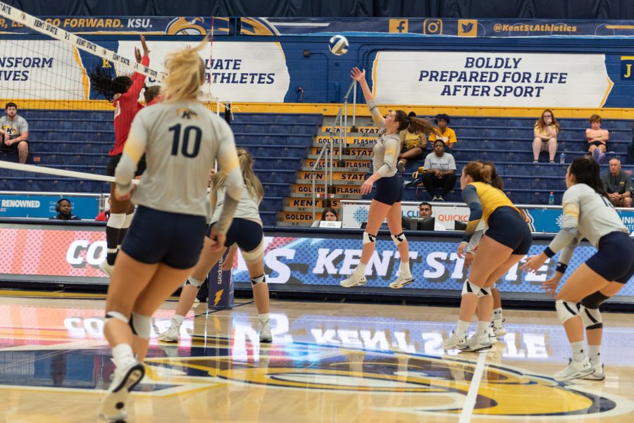 Outside hitter Mackenzie McGuire hits the ball back over the net as the opposing team sets up a block against Cornell. McGuire led her team in kills that game with 15.