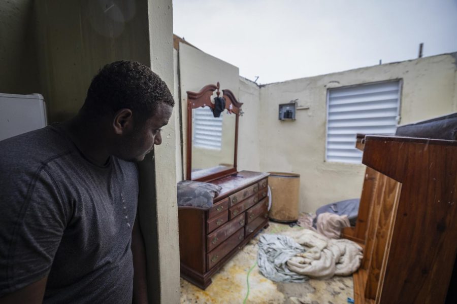 A+man+looks+at+his+bedroom+after+the+winds+of+Hurricane+Fiona+tore+the+roof+off+his+house+in+Loiza%2C+Puerto+Rico%2C+on+Sunday.