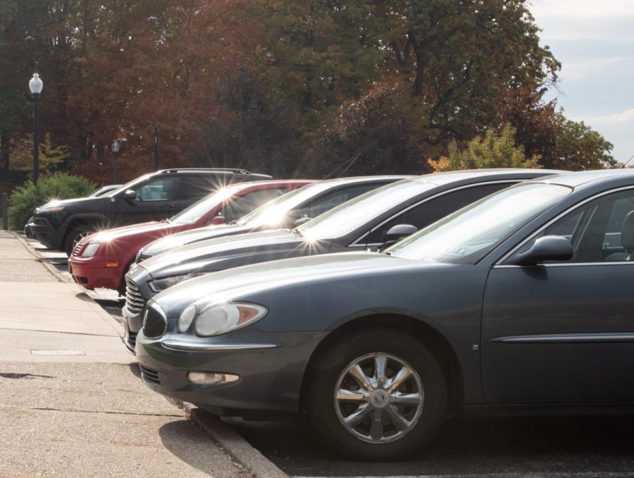 Cars line the sidewalk of the Prentice parking lot.