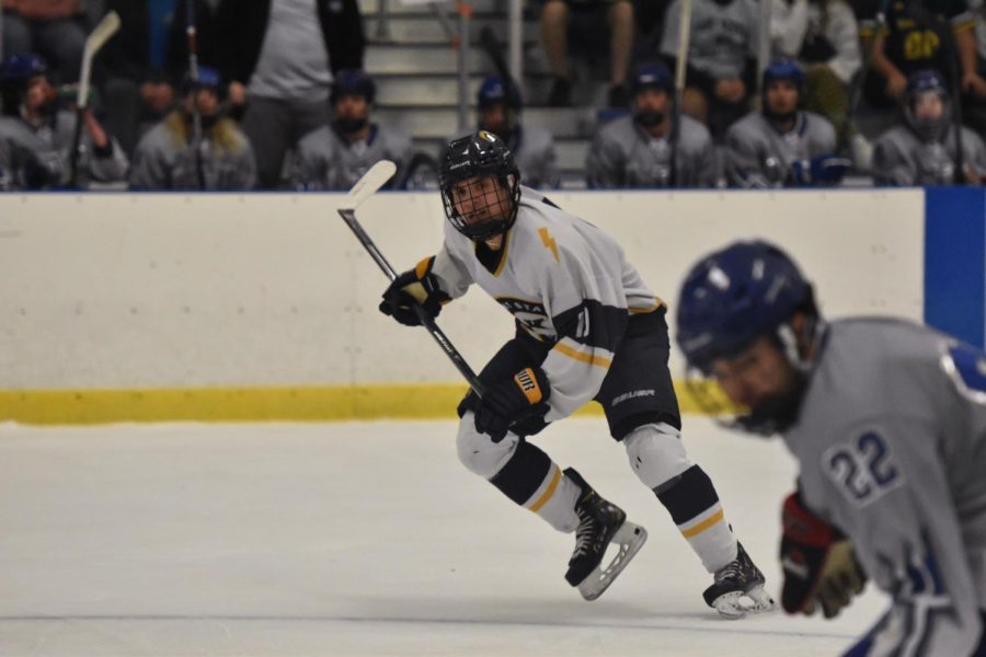 A Kent State hockey team member chases his Lawrence Tech opponent down the rink.