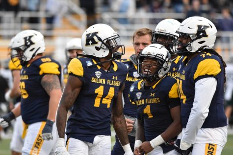 The Kent State football team celebrates after scoring a touchdown.