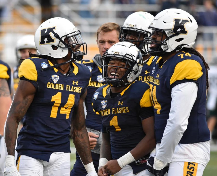 The Kent State football team celebrates after scoring a touchdown.