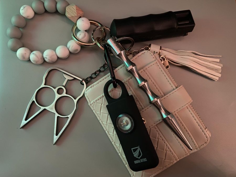 My+keychain%2C+featuring+my+wallet+and+a+variety+of+self-defense+tools%3A+cat-shaped+brass+knuckles%2C+a+self-defense+alarm%2C+a+blunt+object+and+pepper+spray.