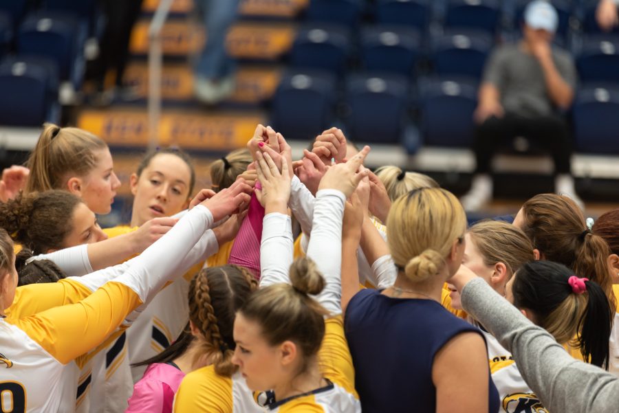 The Kent State Golden Flash volleyball team gather together before the game.
