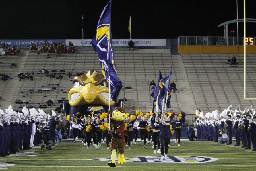 Flash the Eagle leads the charge as the Kent State cheerleaders and football team take to the field during the game against Ball State on Nov. 02, 2022.