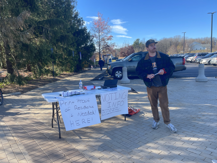 Connor Compton, a worker at the Ohio Democratic Party, stands outside Kent States Recreation and Wellness Center for students who need a proof of residence document printed out. Compton said he would be there all day until the polls close.