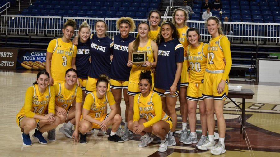 The Kent State womens basketball players hold the Christmas Classic Trophy Nov. 27. The team won the title after defeating Quinnipiac and Southern Illinois.  
