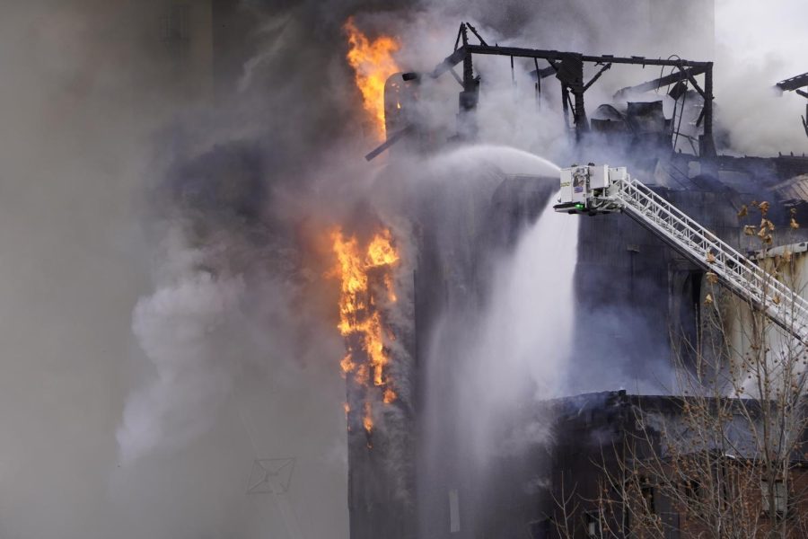 Water sprays the flames on the side of the mill.
