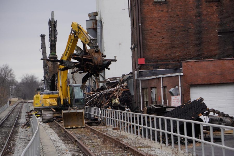 Moving down the train tracks, the operator moves the debris to a separate pile.