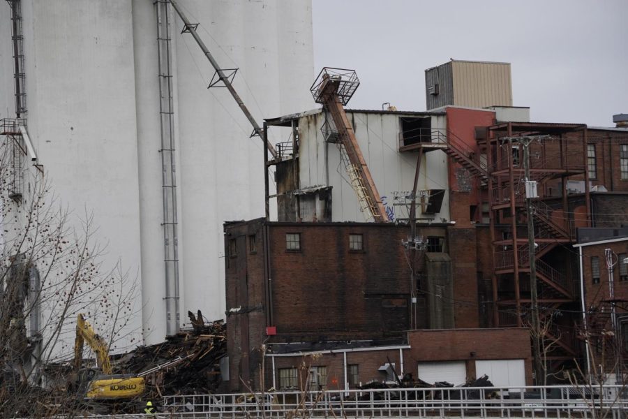 The ladder, previously attached to the mill, is now leaning against another part of the building.