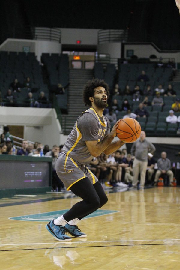 Point Guard Sincere Carry shoots a three in Kent States 67-58 win over Cleveland State on Saturday afternoon.