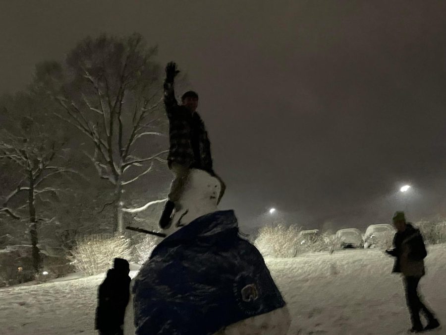Student Drew Weber riding the giant snowman.